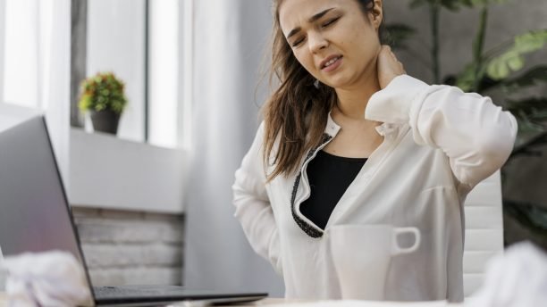 woman-having-neckache-while-working-home